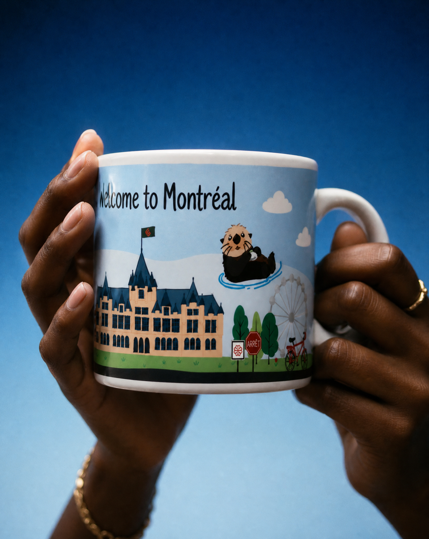 Hands holding the Welcome to Montréal otter mug